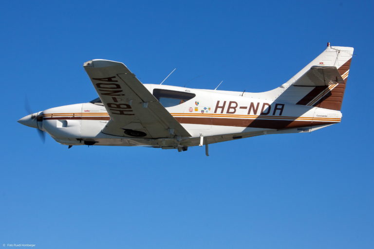 Propeller airplane flying in clear blue sky