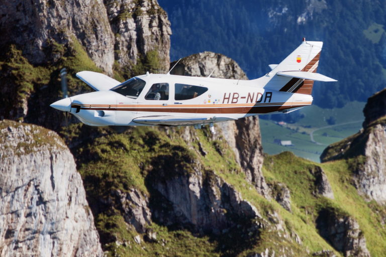 Small plane flying over mountainous landscape