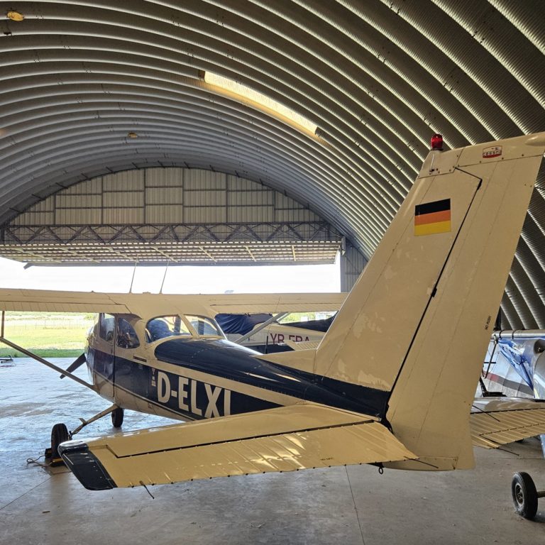 Airplane parked in a large hangar