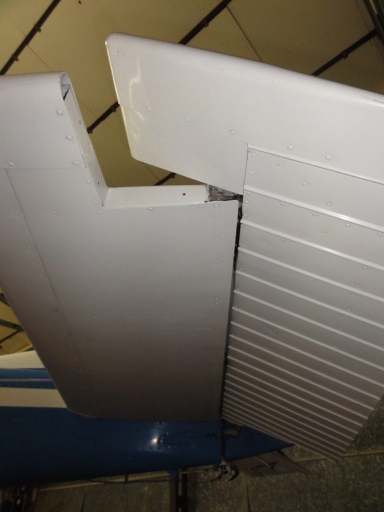 Airplane wing with aileron detail inside hangar.