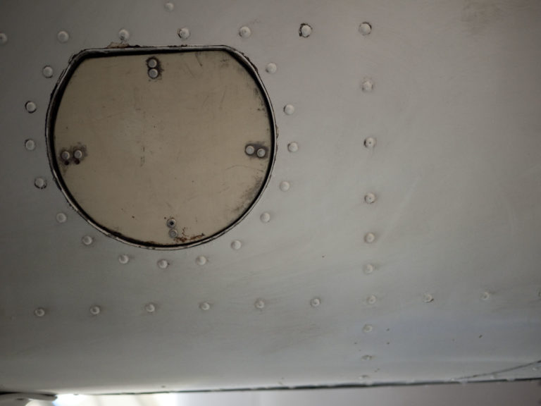 Close-up of metal panel with rivets.