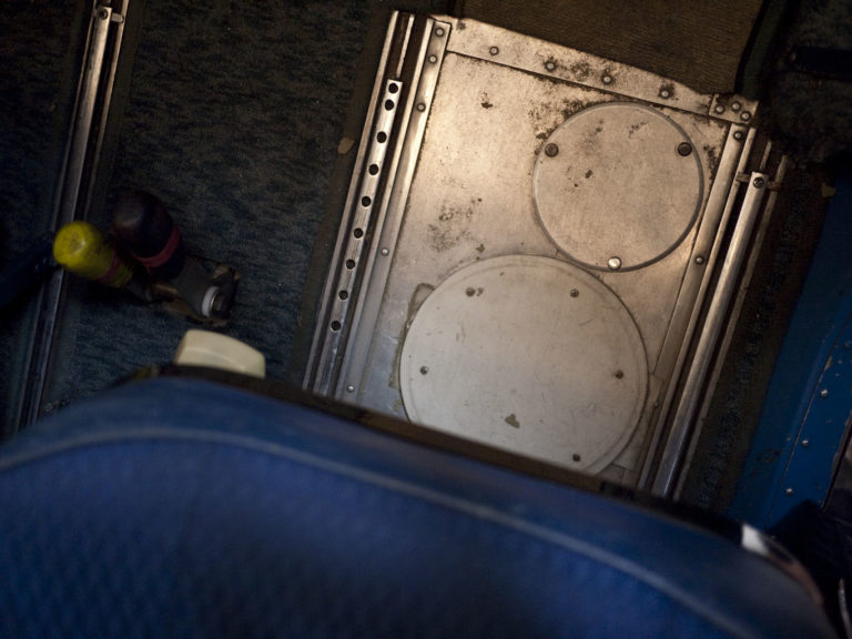 Airplane cockpit floor view with controls
