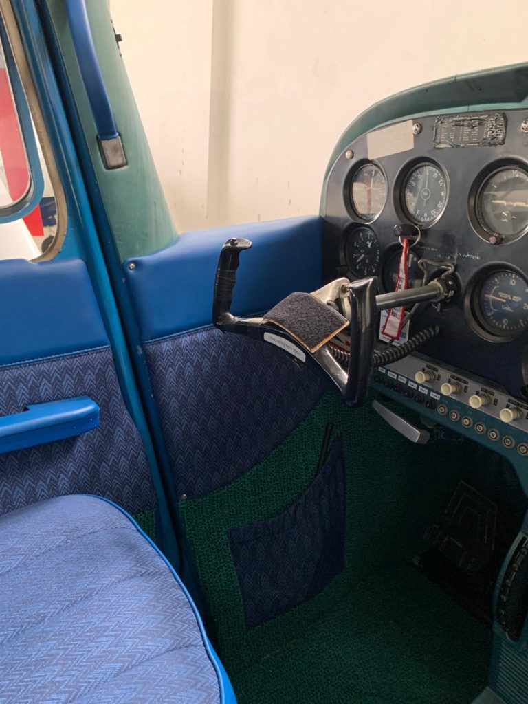 Cockpit interior with flight controls and instruments visible.