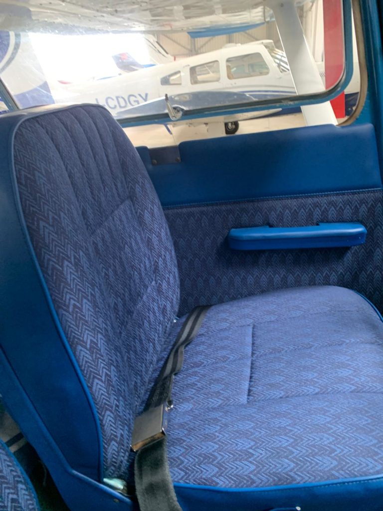 Blue aircraft interior with patterned seats.