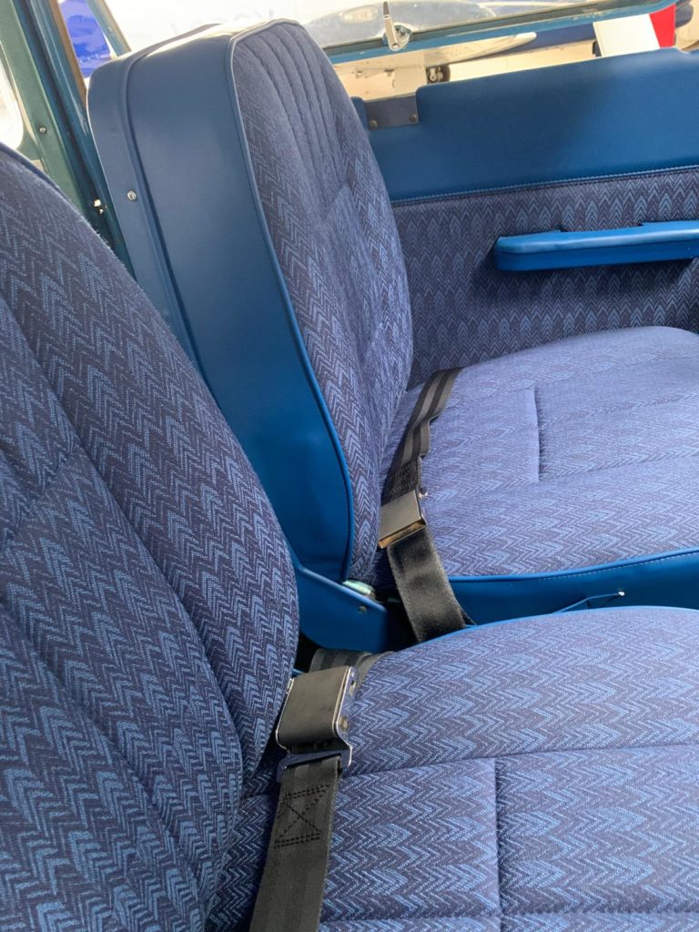 Blue retro car seats with seatbelts.