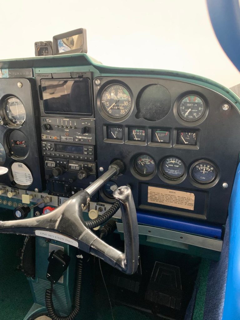 Airplane cockpit instruments and controls close-up view.