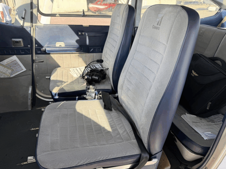 Cessna aircraft interior with seats and headset.