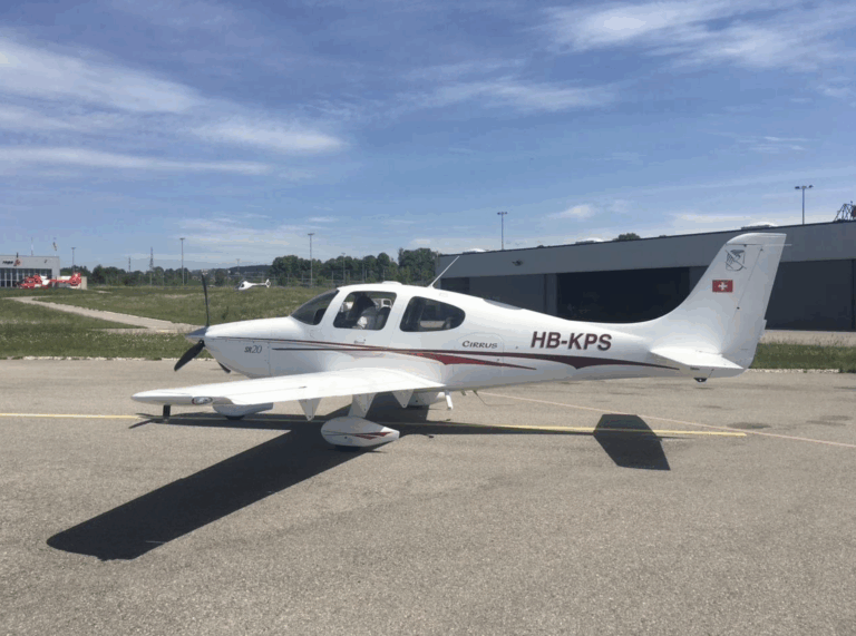 Small white airplane on airport tarmac