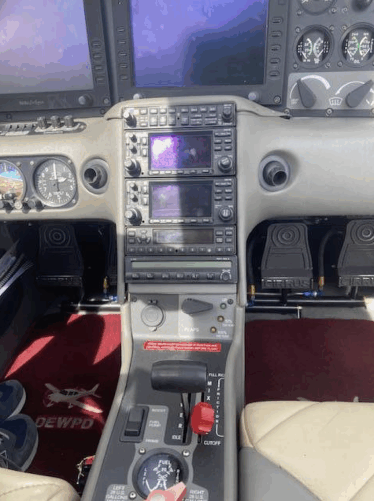 Small aircraft cockpit dashboard and controls.