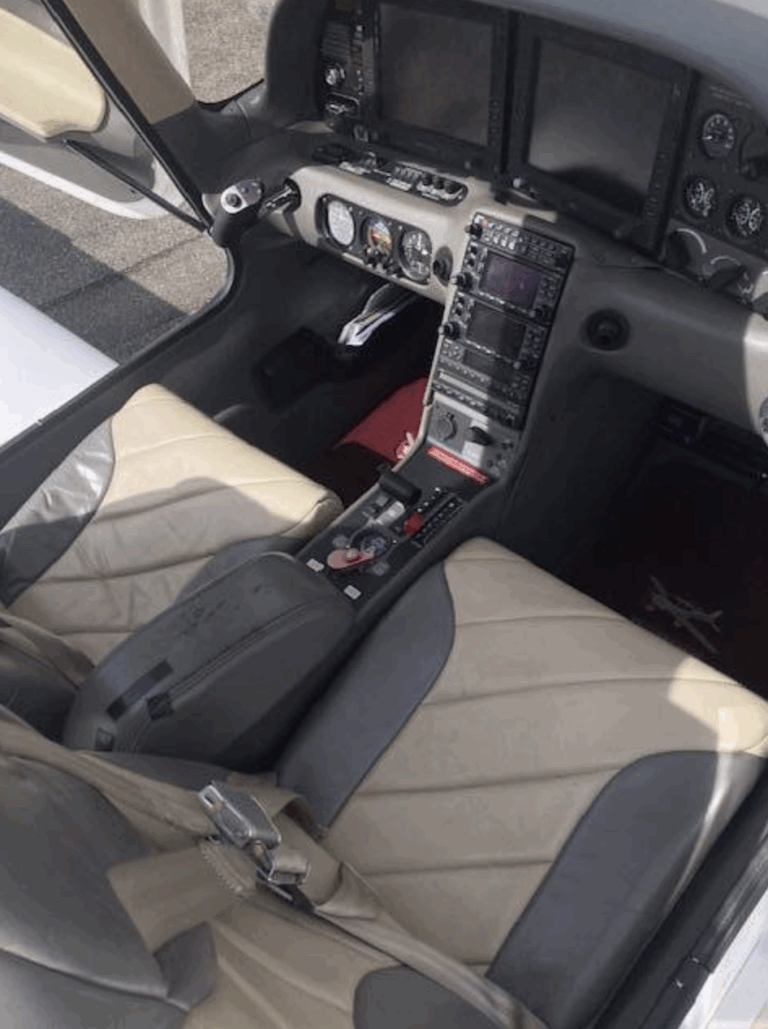 Small airplane cockpit interior with instruments.