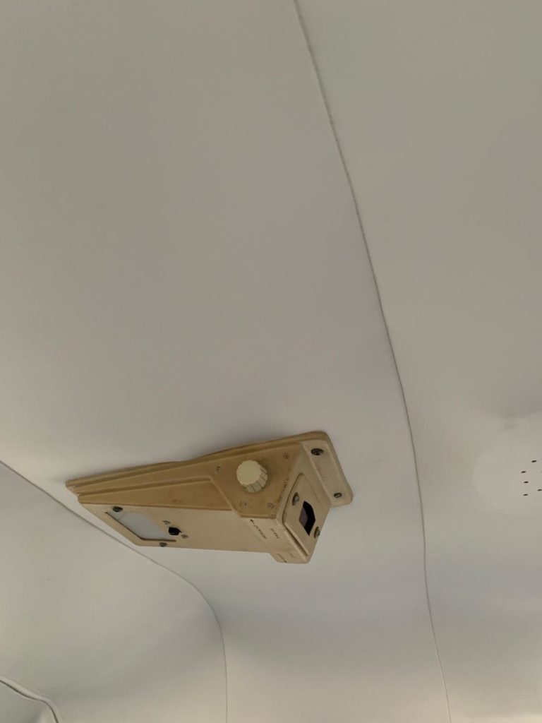 Airplane overhead panel with light switch.