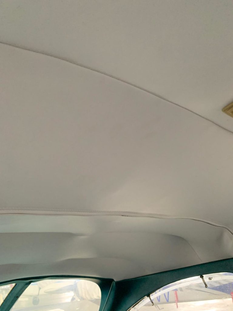 Interior car roof with stitched seam detail.