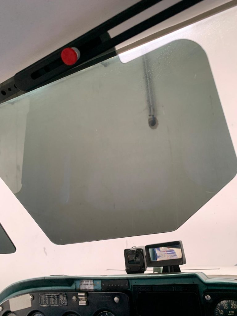 Cockpit view with window and dashboard instruments.